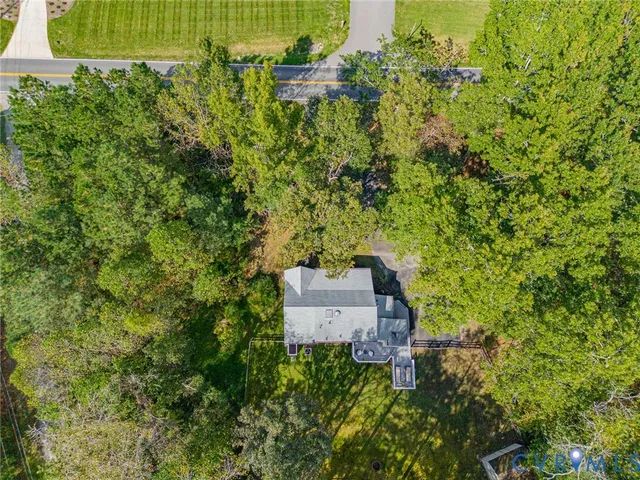 an aerial view of a house with a yard