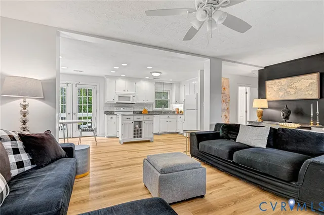 a living room with furniture and kitchen view