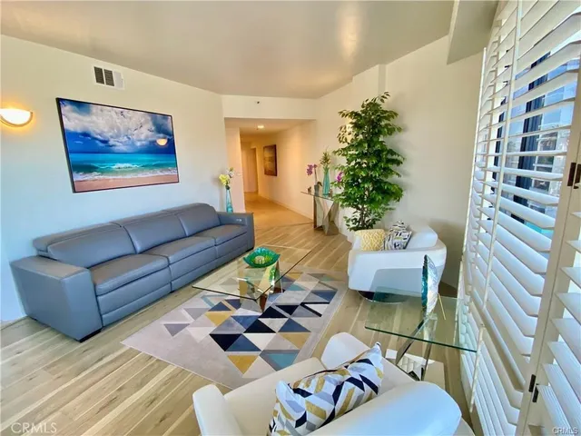 a living room with furniture and a potted plant