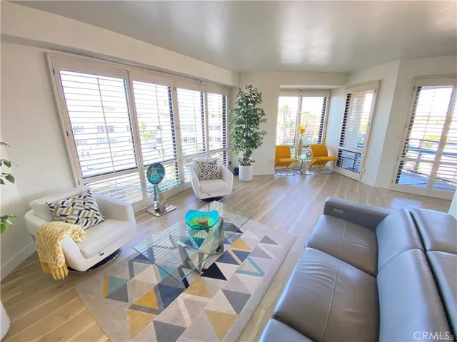 a living room with furniture and a floor to ceiling window