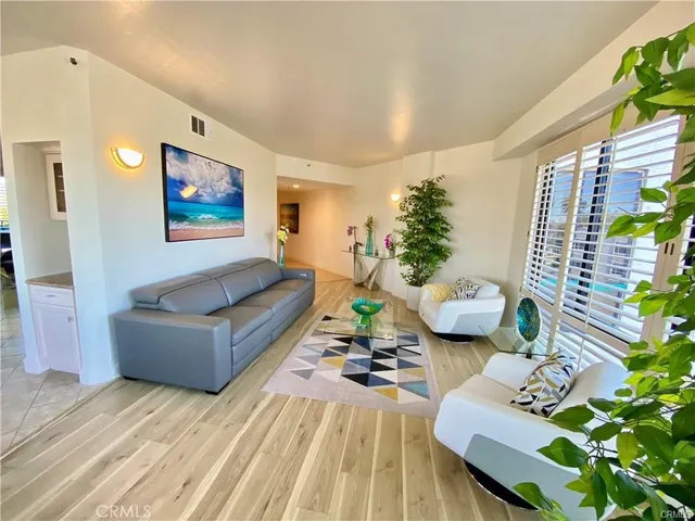 a living room with furniture and floor to ceiling windows