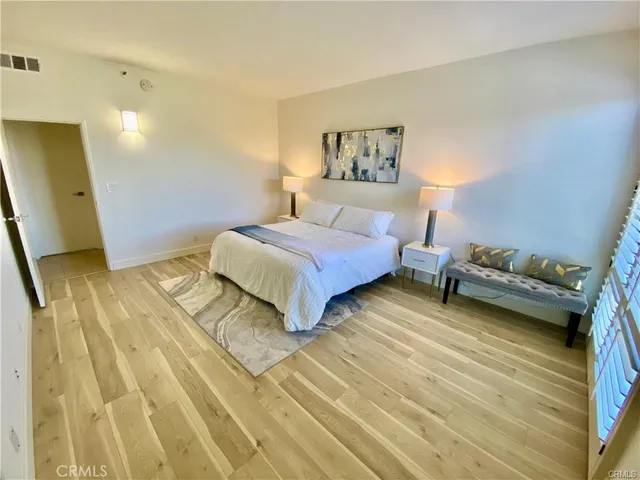a bedroom with a bed a table and chair