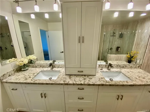 a bathroom with a sink a toilet and mirror