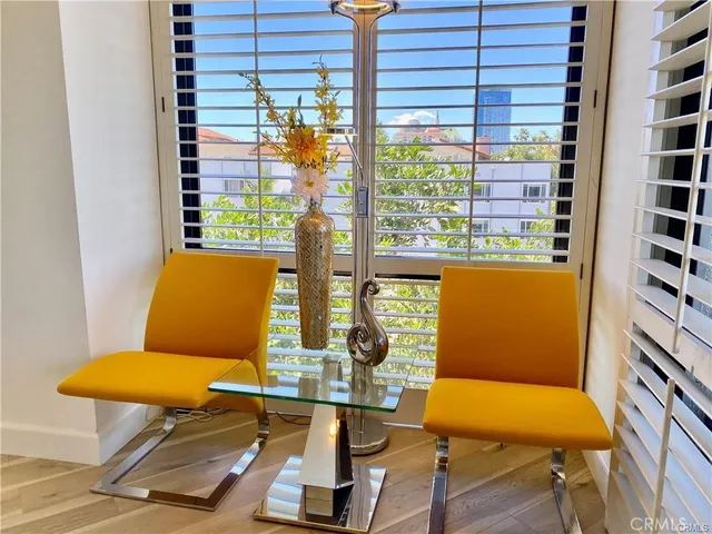 a dining room with furniture and large windows