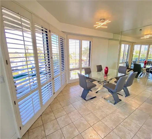 a work room with furniture and large windows