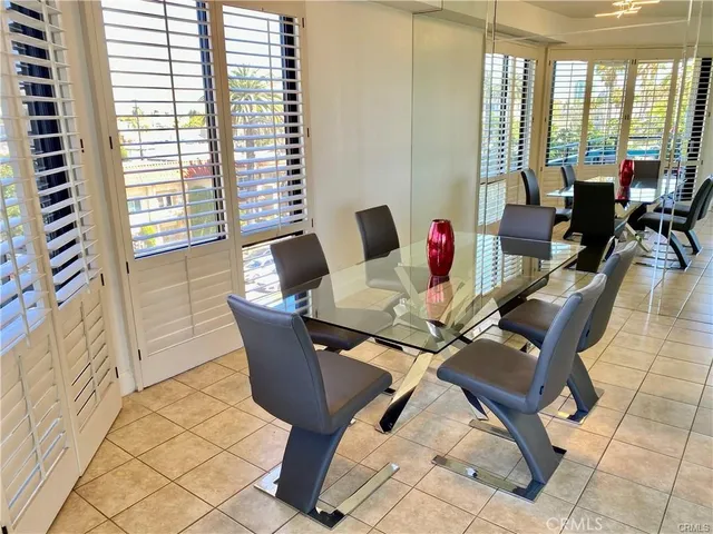 a living room filled with furniture and a potted plant