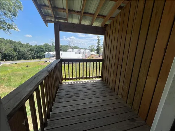 a view of a balcony with wooden floor