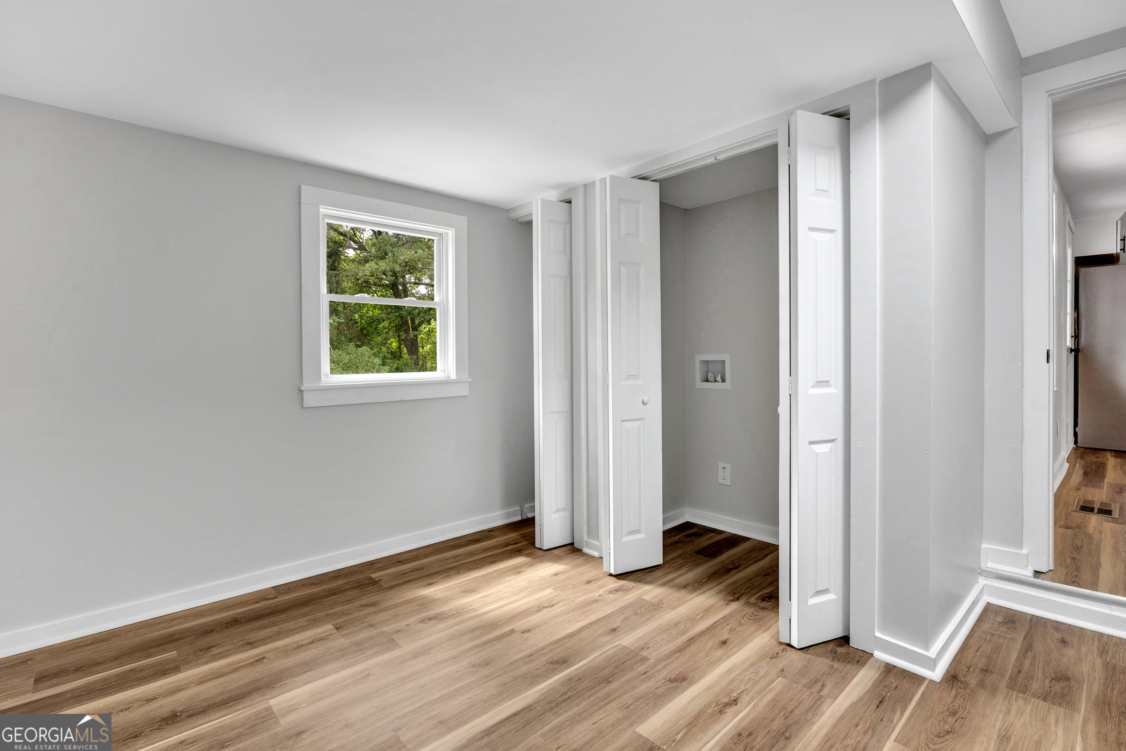 455 Cindy Street Jackson, GA 30233 - Photo 13 of 25 an empty room with wooden floor and a window