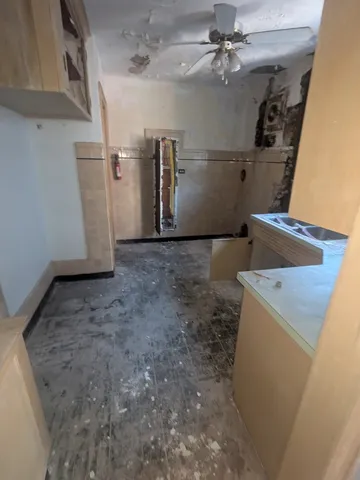 a view of a storage & utility room with a sink