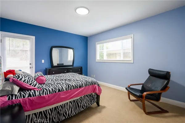 a bedroom with a bed chair and a window
