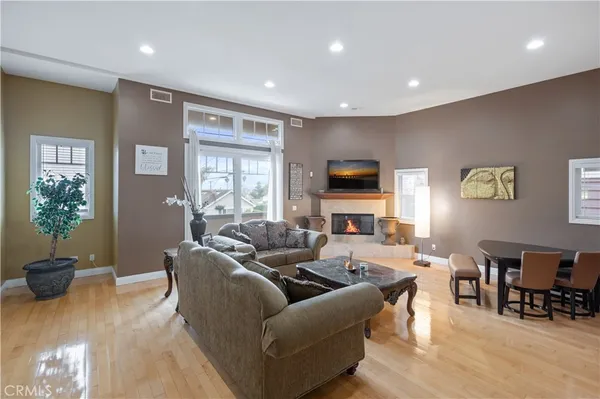 a living room with furniture a window and a flat screen tv