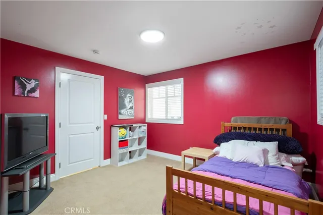 a bedroom with furniture and a flat screen tv