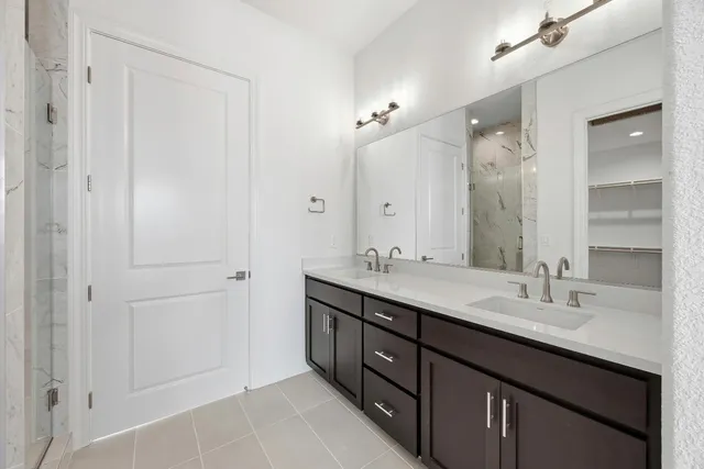 a bathroom with 2 sink and a mirror