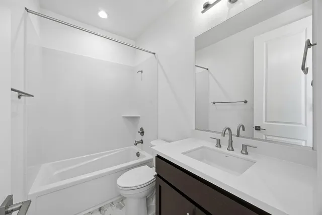 a bathroom with a sink toilet tub and shower