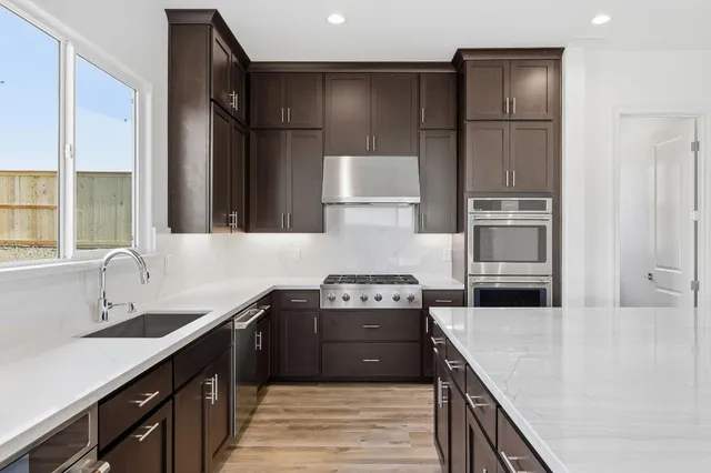 a kitchen with a sink stove and refrigerator