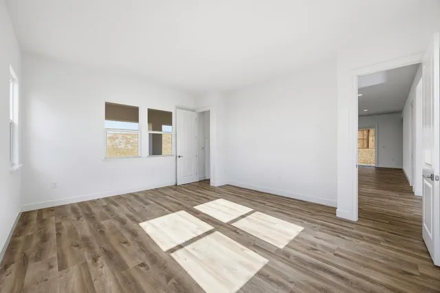a view of wooden floor and windows in a room