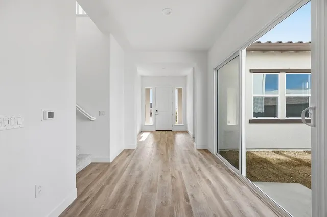 a view of a room with wooden floor and stairs