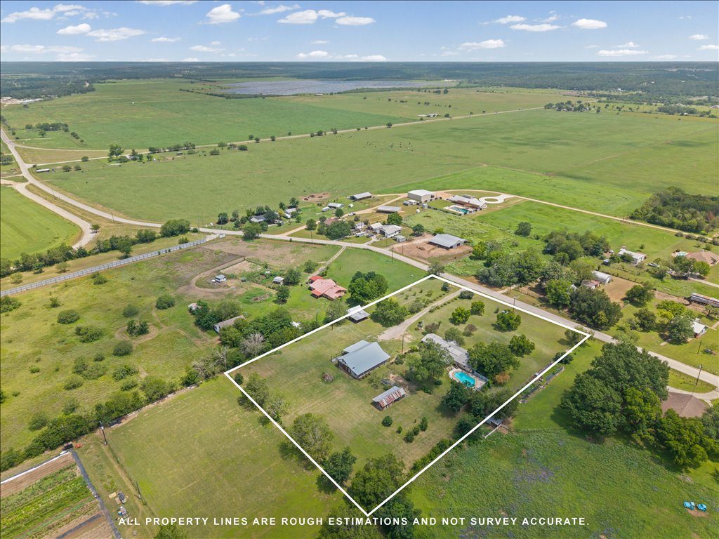 2421 Post Oak Road Webberville, TX 78653 - Photo 34 of 36 Look at all that beautiful, rolling Texas countryside. You are tucked away in a peaceful rural pocket, completely surrounded by large acreage tracts and green fields, yet you still have easy road access. It’s the perfect blend of feeling totally disconnected from the hustle and bustle while having a secure, established piece of land to call your own.