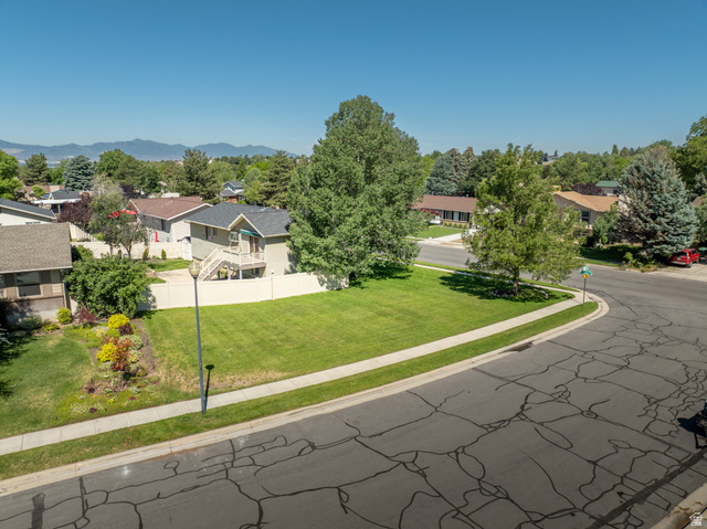 2088 Falcon Way Sandy, UT 84093 - Photo 36 of 46 Expansive corner lot featuring a manicured lawn, established trees, and mature landscaping
