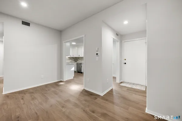a view of a kitchen with a sink and wooden floor