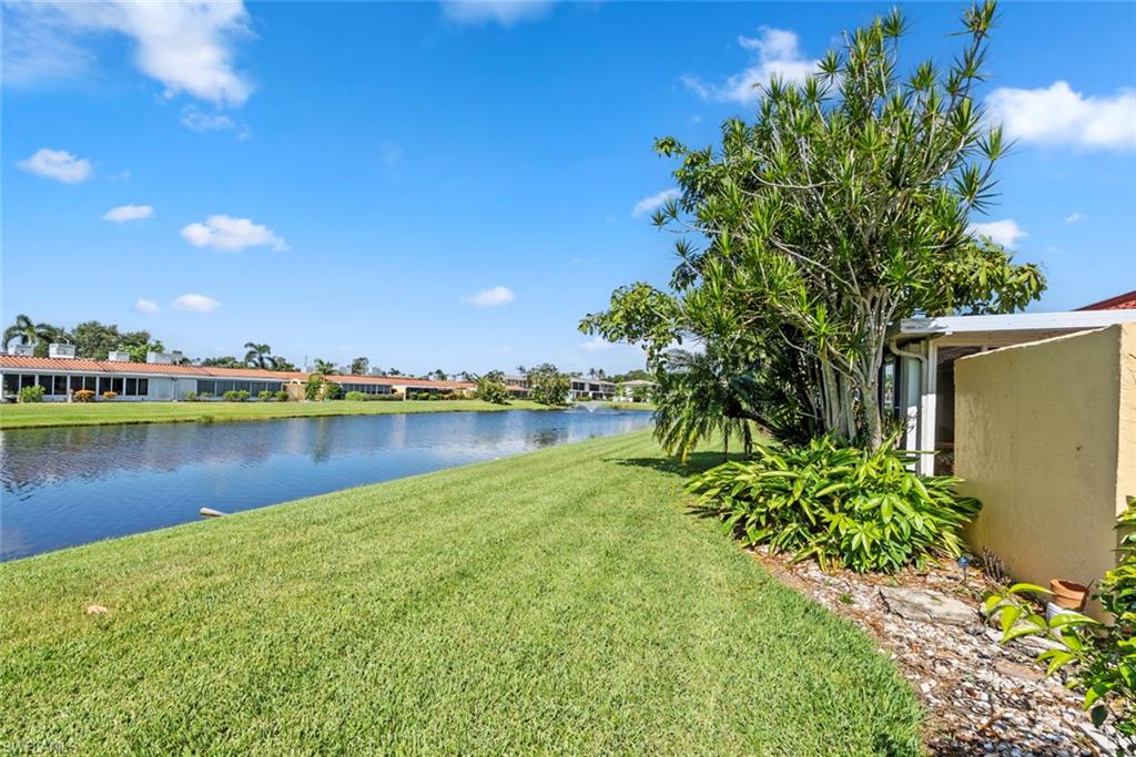 136 Harrison Road, Unit 1 Naples, FL 34112 - Photo 19 of 29 Expansive waterfront property featuring a manicured lawn leading to a serene canal