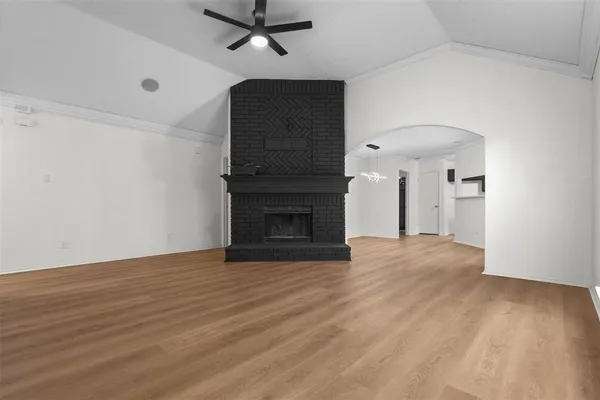 wooden floor in an empty room with a fireplace