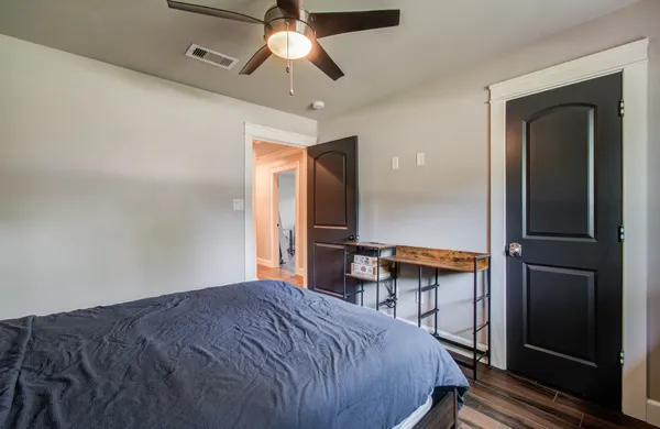 a bedroom with a bed and a chandelier