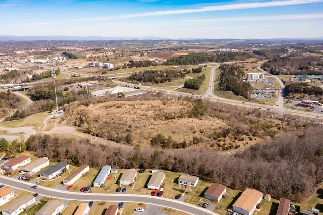 a view of a dry yard with mountains in the background