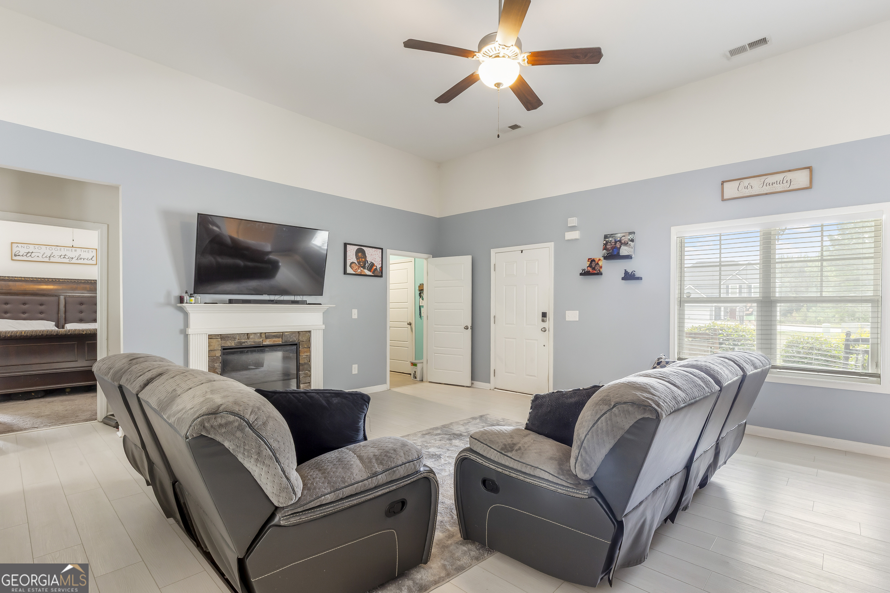 370 Springwater Way Bremen, GA 30110 - Photo 7 of 32 a living room with furniture a fireplace and a flat screen tv