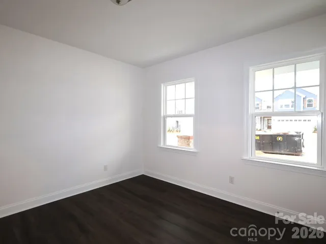 an empty room with wooden floor and closet