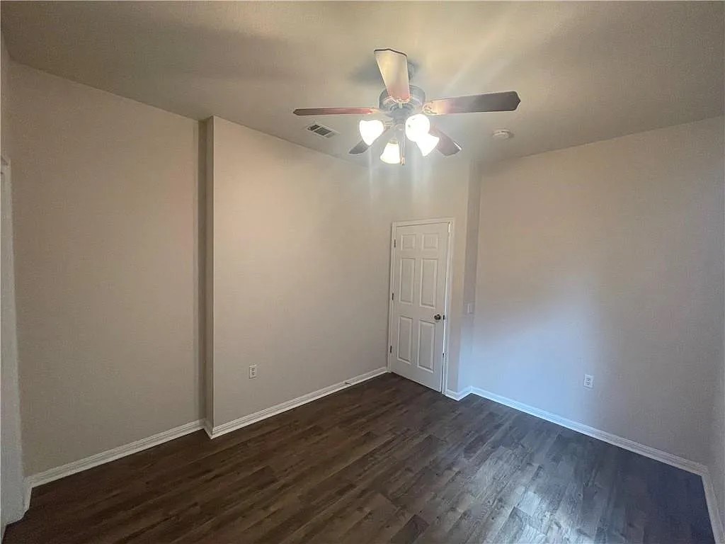 5701 Signal Point Austin, TX 78724 - Photo 7 of 12 Room with wood-finish flooring, light-toned walls, and white trim