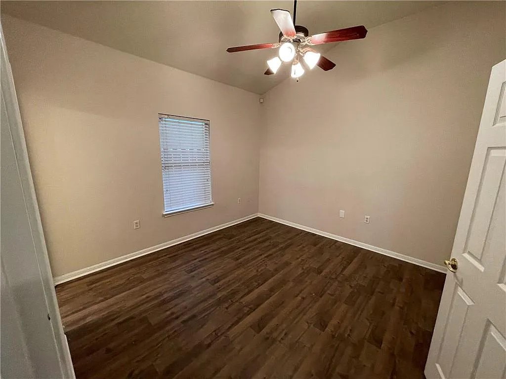 5701 Signal Point Austin, TX 78724 - Photo 8 of 12 Interior room featuring wood-finish flooring, a vaulted ceiling, and a ceiling fan with integrated lighting