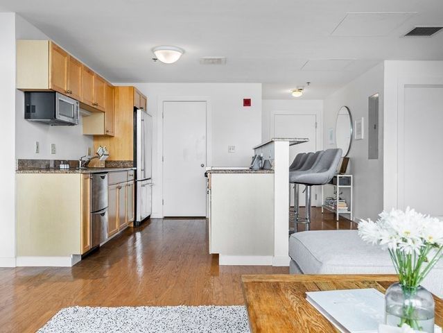 a spacious bedroom with a bed and a large window