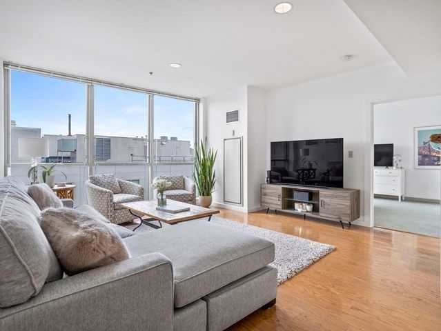 a living room with furniture and a rug