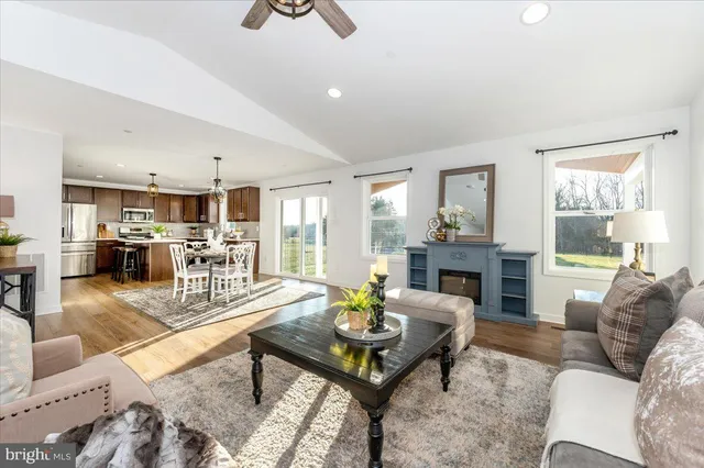 a living room with dining room and wooden floor