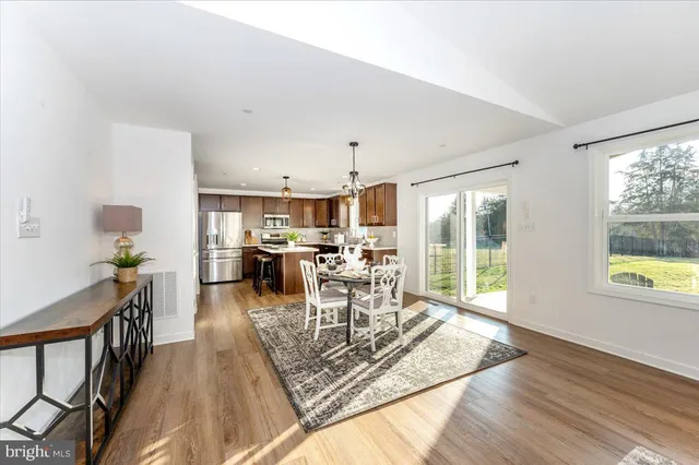 a living room with lots of furniture and a large window