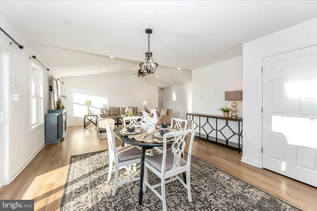 a kitchen with granite countertop wooden floors a center island stainless steel appliances and cabinets