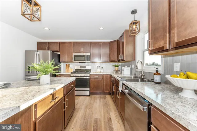 a dining room with table chairs and potted plants