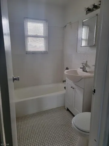 a bathroom with a toilet a sink and bathtub