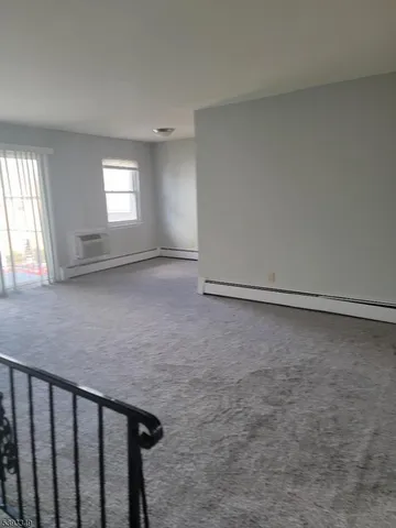 a view of a livingroom with wooden floor and a window