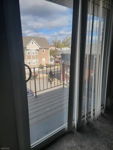 a view of a balcony with wooden floor and fence