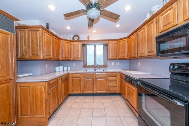 a kitchen with stainless steel appliances granite countertop a sink and cabinets