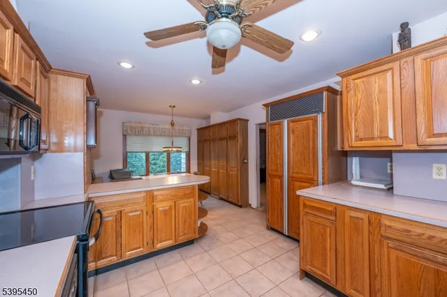 a kitchen with stainless steel appliances granite countertop a sink and cabinets