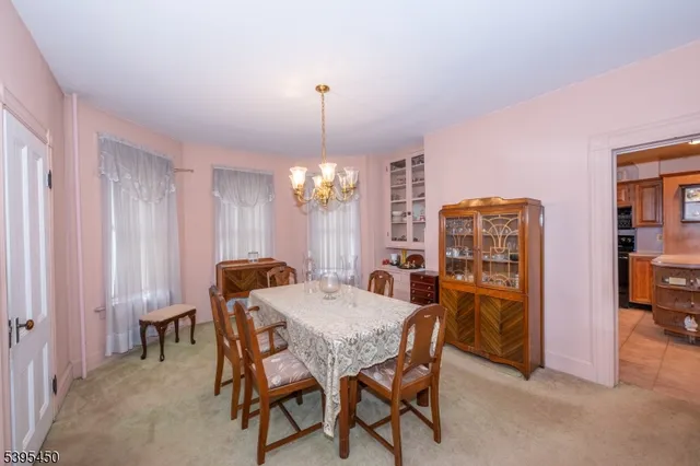 a view of a dining room with furniture and chandelier