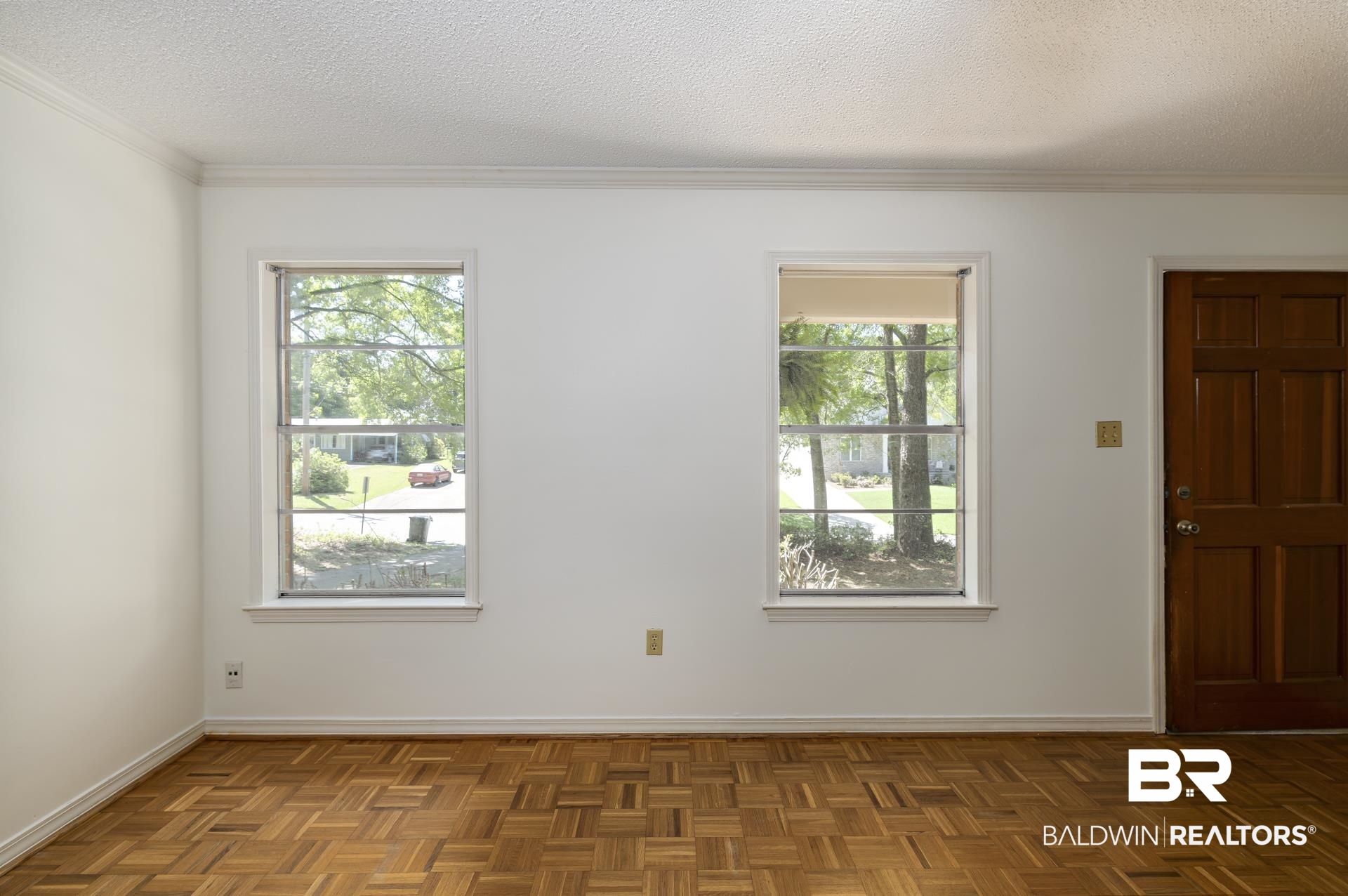 707 Johnson Avenue Fairhope, AL 36532 - Photo 15 of 38 Spare room featuring a textured ceiling, baseboards, and ornamental molding