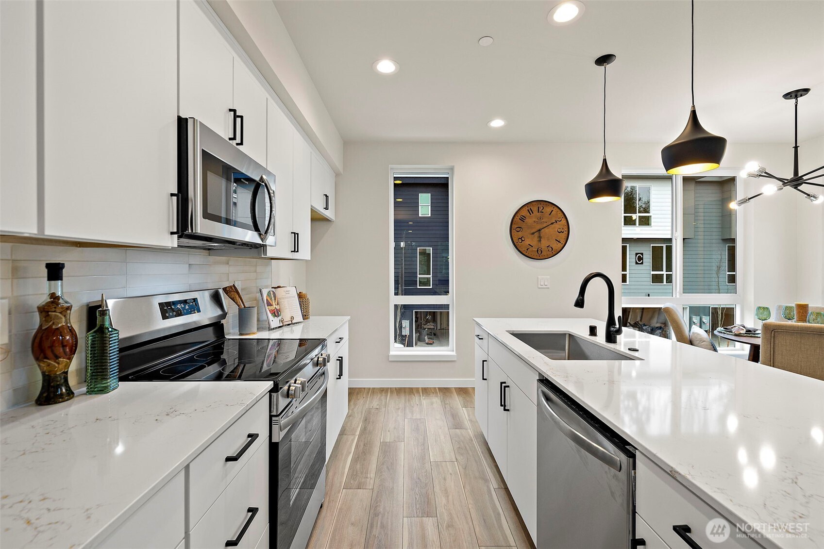 5015 144th Street Southwest, Unit C3 Edmonds, WA 98026 - Photo 11 of 30 a kitchen with stainless steel appliances granite countertop a sink a stove and a wooden floors