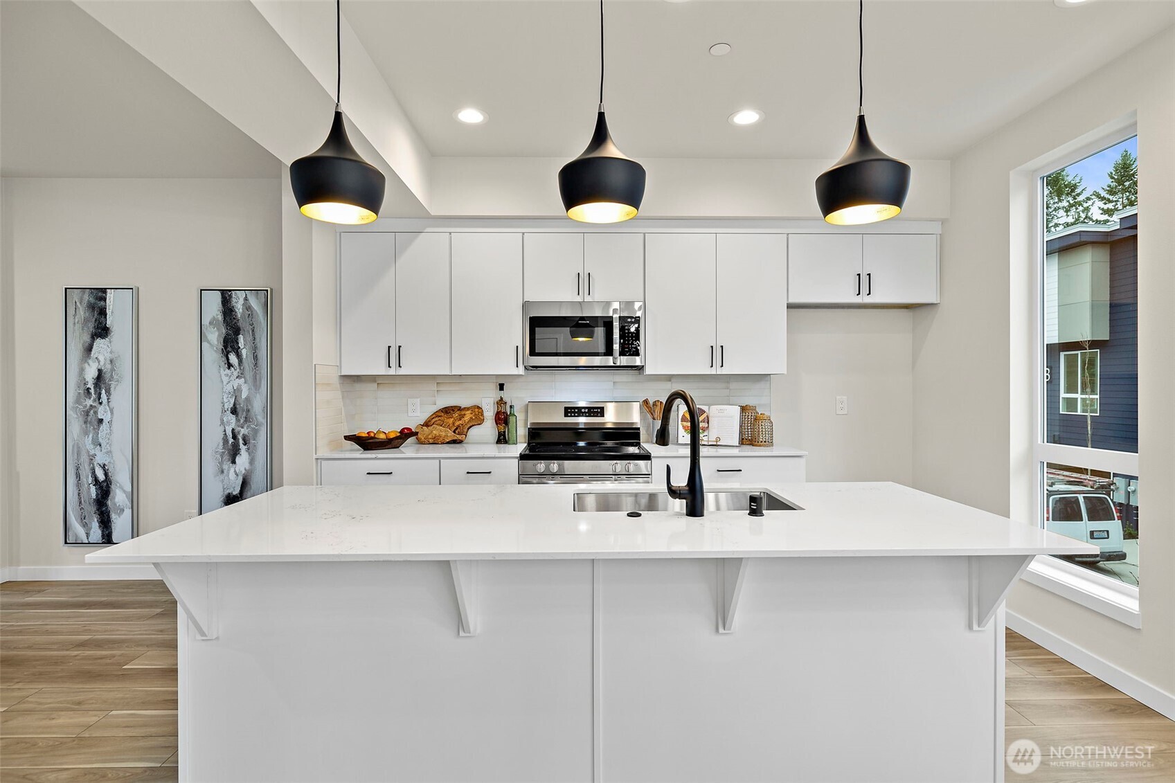 5015 144th Street Southwest, Unit C3 Edmonds, WA 98026 - Photo 8 of 30 a kitchen with stainless steel appliances a stove a sink a microwave a center island and cabinets