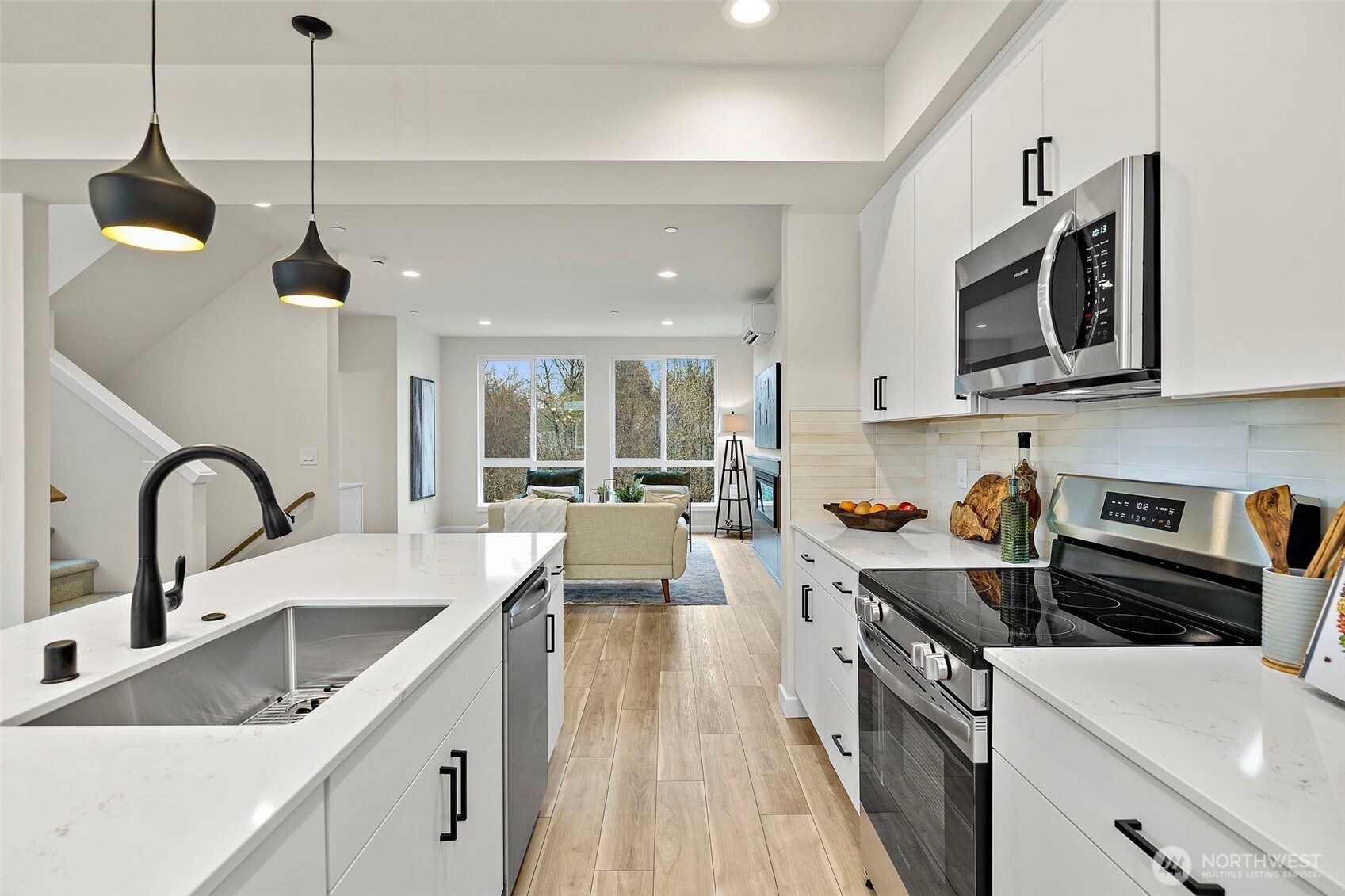 5015 144th Street Southwest, Unit C3 Edmonds, WA 98026 - Photo 9 of 30 a kitchen with stainless steel appliances a sink a stove a oven a counter space and cabinets