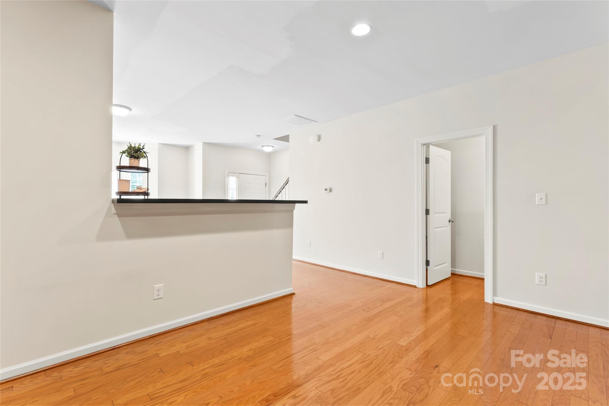 5678 Stafford Road Charlotte, NC 28215 - Photo 12 of 43 an empty room with wooden floor and windows