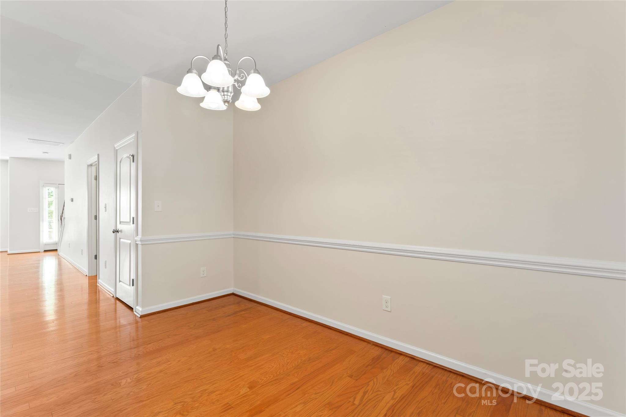 5678 Stafford Road Charlotte, NC 28215 - Photo 17 of 43 a view of a room with wooden floor and chandelier